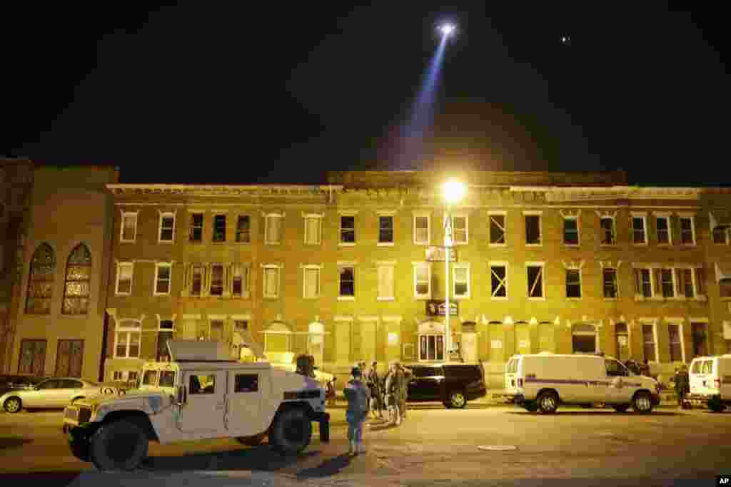 National Guard stand by during a 10 p.m. curfew in Baltimore, April 29, 2015.