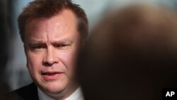 FILE - Finland's Defense Minister Antti Kaikkonen answers to reporters as he arrives for a meeting of NATO defense ministers at NATO headquarters in Brussels, Oct. 12, 2022.