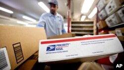 FILE - Packages wait to be sorted in a post office in Atlanta, Feb. 7, 2013.