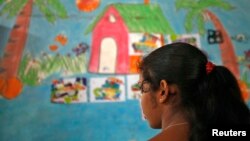 A 16-year-old girl stands inside a protection home on the outskirts of New Delhi, Nov. 9, 2012. She was rescued by Bachpan Bachao Andolan (Save the Childhood Movement), a charity which rescues victims of bonded labor. In the state of West Bengal, police officers are helping rescued women to make a new life.
