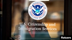 FILE - A woman leaves U.S. Citizenship and Immigration Services offices in New York, Aug. 15, 2012.