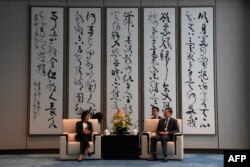 US Commerce Secretary Gina Raimondo (L) talks with Shanghai Party Secretary Chen Jining during a meeting in Shanghai on August 30, 2023.