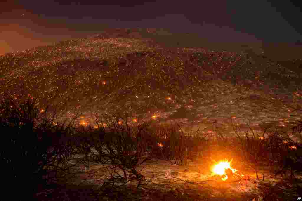 Embers from a wildfire smolder along Lytle Creek Road near Keenbrook, California, Aug. 17, 2016.
