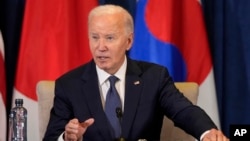 FILE - U.S. President Joe Biden speaks during a meeting with leaders of Japan and South Korea in Lima, Peru, Nov. 15, 2024. He will visit the African nations of Cabo Verde and Angola next week.
