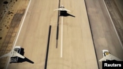 FILE - Iranian versions of the American RQ-170 drone which were used in a military exercise in the Gulf in Iran, involving dozens of drones, are seen on a runway, in this undated handout photo. 