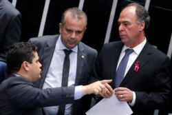 Brazil's President of the Senate Davi Alcolumbre speaks with Secretary of Social Security Rogerio Marinho and Senator Fernando Bezerra during a session to vote on a pension reform bill at the Federal Senate in Brasilia, Oct. 1, 2019.