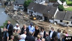 German Chancellor Angela Merkel and Rhineland-Palatinate State Premier Malu Dreyer are seen on a bridge during their visit in the flood-ravaged areas in Schuld near Bad Neuenahr-Ahrweiler, Rhineland-Palatinate state, western Germany, July 18, 2021.