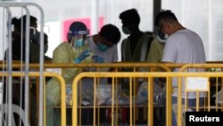Medical personnel sort out medical supplies at a dormitory during the coronavirus disease (COVID-19) outbreak in Singapore, April 20, 2020.