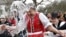 Men throw water on a woman as part of traditional Easter celebrations in Szenna, Hungary, March 28, 2016. 
