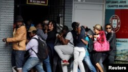 Students demanding free education react as they are fired at by riot police officers during a protest outside the University of the Witwatersrand in Johannesburg in October.