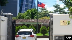 FILE - A diplomatic car enters the Embassy of Taiwan in San Salvador on August 21, 2018.