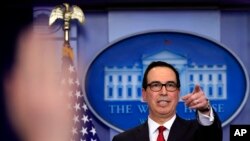 FILE - Treasury Secretary Steven Mnuchin, gestures during a White House daily press briefing in the Brady press briefing room at the White House, in Washington, Jan. 11, 2018.