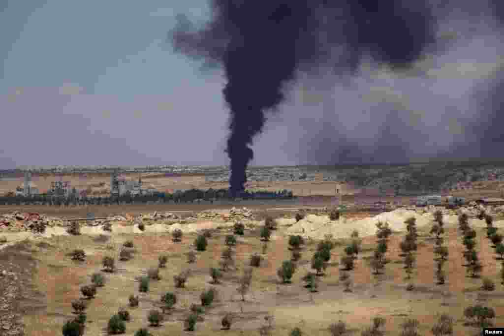 Smoke rises near the village of Hilan due to shelling by forces loyal to President Bashar al-Assad, May 21, 2014.