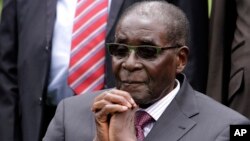 File - Zimbabwe President Robert Mugabe listens after a swearing-in ceremony at the State House in Harare, Zimbabwe.
