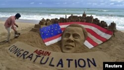 Patnaik, an Indian artist gives finishing touches to a sand sculpture of U.S. President Obama on a beach in Puri, India.