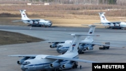 FILE - Russian servicemen load medical equipment and special disinfection vehicles into cargo planes to be sent to Italy, hit by the outbreak of COVID-19, at a military airdrome in the Moscow region, March 22, 2020.