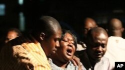 A woman who lost a relative in a bomb explosion, center, mourns at the Asokoro General Hospital, Abuja, Nigeria, 31 Dec 2010