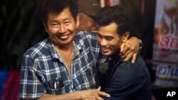 FILE - Family members hug after hearing the news that the missing 12 boys and their soccer coach have been found in the flooded cave in Mae Sai, Chiang Rai province, northern Thailand, July 2, 2018.