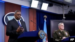 Defense Secretary Lloyd Austin, left, and Joint Chiefs Chairman Gen. Mark Milley participate in a briefing at the Pentagon in Washington, May 6, 2021.