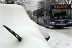 Snow covers parked vehicles after an overnight snowfall on Western Avenue, in Albany, N.Y., Dec. 2, 2019.