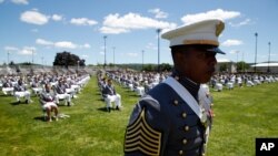 United States Military Academy graduating cadets queue to present themselves on stage as their names are called during commencement ceremonies, June 13, 2020, in West Point, N.Y. 