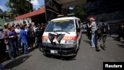 An ambulance carrying the bodies of those killed in the fire exits the Virgen de Asuncion home, in San Jose Pinula, on the outskirts of Guatemala City, Guatemala, March 8, 2017. 