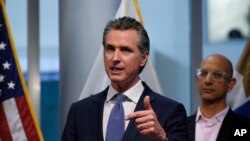 A woman lights a candle on her balcony as faithful across Italy say a prayer for people suffering from coronavirus disease (COVID-19), in Rome, March 19, 2020.