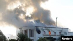 Smoke rises from the site of the headquarters of Libya's foreign ministry after suicide attackers hit in Tripoli, Libya Dec. 25, 2018.