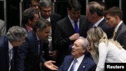President of Brazil's Supreme Court, Ricardo Lewandowski (seated) speaks with senators during a discussion before the Senate votes on whether suspended President Dilma Rousseff should stand trial for impeachment, in Brasilia, Brazil, August 9, 2016.