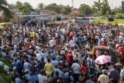 Supporters of the Union for Democracy and Social Progress and Democratic Republic of Congo President Felix Tshisekedi, gather near party headquarters in Kinshasa on Dec. 6, 2020, to hear a speech from the President.