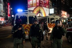 Police in full protective gear patrol a street in Hong Kong, Oct. 5, 2019.