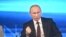 Russian President Vladimir Putin takes part in a live broadcast nationwide phone-in, in Moscow, Apr. 17, 2014. 
