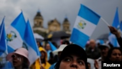 FILE - Demonstrators take part in a protest against Guatemalan President Jimmy Morales and his decision not to renew the mandate of the CICIG, in Guatemala City, Guatemala, Sept. 1, 2018. 