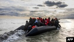 Migrants board a smuggler's boat in an attempt to cross the English Channel, near Dunkirk, France, on April 26, 2024. A human rights group announced on May 3 that it will ask the courts to stop the U.K.'s plan to send asylum seekers to Rwanda.
