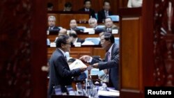 លោក​នាយករដ្ឋមន្ត្រី​ ហ៊ុន សែន​ និយាយ​ទៅ​កាន់​​ លោក​ សម រង្ស៊ី ប្រធាន​គណបក្ស​សង្គ្រោះ​ជាតិ​ក្នុង​អំឡុង​ពេល​សម្រាក​​ពី​កិច្ចប្រជុំ​មួយ​នៅ​ក្នុង​​មន្ទីរ​រដ្ឋសភា​ជាតិ​នៅ​ក្នុង​រាជធានី​ភ្នំពេញ កាល​ពី​ថ្ងៃ​ទី​២៨ ខែ​វិច្ឆិកា ឆ្នាំ​២០១៤។ Reuters