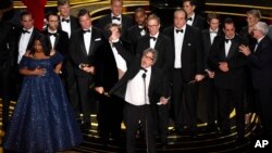 Peter Farrelly, tengah, beserta pemain dan awak “Green Book” menerima penghargaan film terbaik untuk Oscars hari Minggu, 24 Februari 2019, di Dolby Theatre di Los Angeles (foto: Chris Pizzello/Invision/AP)