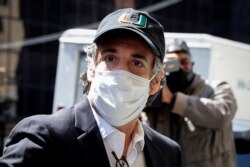 FILE - Michael Cohen, the former personal lawyer for U.S. President Donald Trump, arrives at his Manhattan apartment after being released from federal prison to serve the remainder of sentence under home confinement in New York City, May 21, 2020.