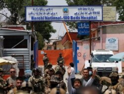 Afghan security forces standing guard outside the Dasht-e-Barchi Hospital which came under attack in Kabul, Afghanistan, May 12, 2020.
