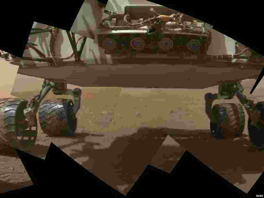 This view of the lower front and underbelly of Curiosity combines nine images taken on September 9, 2012.