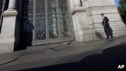 A man, holding a national flag with a poster of Turkey&#39;s founder Kemal Ataturk, watches as thousands of Turks clash with security as they try to break through barricades mounted around the prison and courthouse complex in Silivri, in the outskirts of Istanbul.
