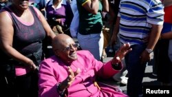 FILE - Archbishop Emeritus Desmond Tutu waves to well-wishers in Cape Town, April 19, 2014.