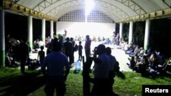 Central Americans are seen in the town of Tantima, Mexico, after Mexican authorities said that they rescued 147 Central Americans abandoned in the wilderness of Veracruz state, in this handout photograph released by the Mexican National Institute of Migration, July 30, 2017.