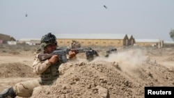 FILE - Iraqi soldiers train with members of the U.S. Army 3rd Brigade Combat Team, 82nd Airborne Division, at Camp Taji, Iraq, in this U.S. Army photo released June 2, 2015. 