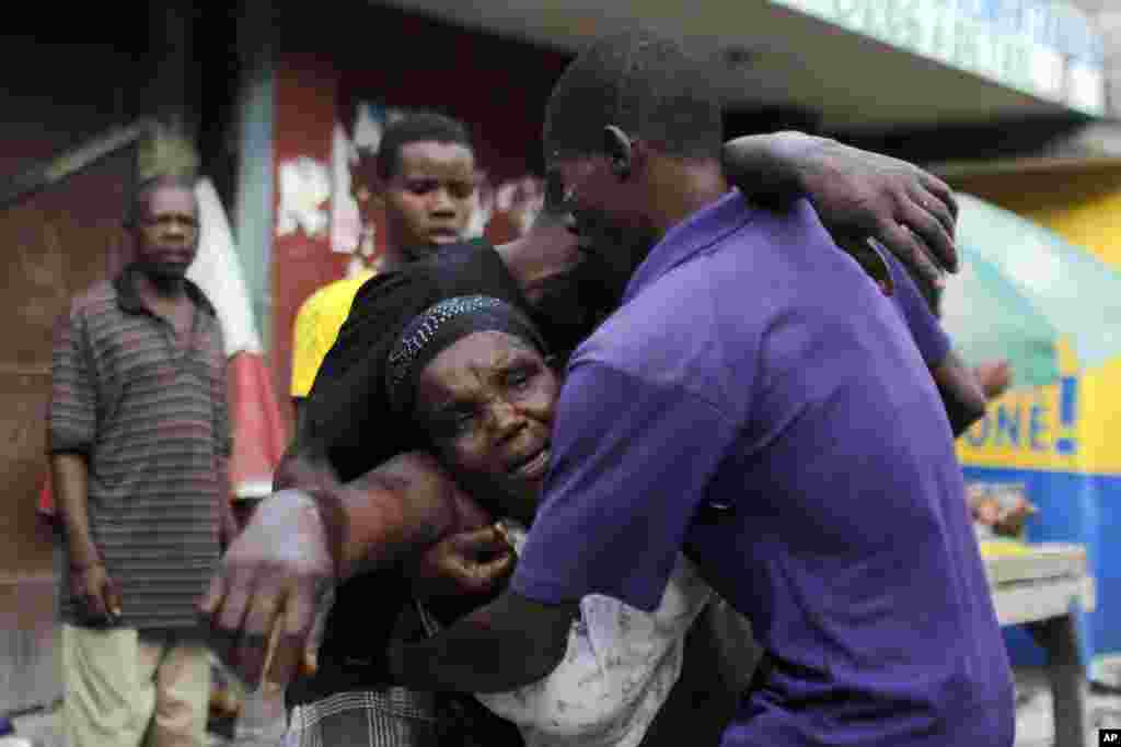 A woman overcome by tear gas is carried away after clashes near her home during a protest by supporters of presidential candidate Maryse Narcisse, of the Fanmi Lavalas political party, in Port-au-Prince, Haiti, Nov. 22, 2016.