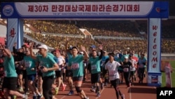 Foreign competitors cross the starting line during the annual 'Mangyongdae Prize International Marathon', at Kim Il Sung stadium in Pyongyang, North Korea, April 7, 2019.