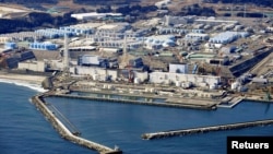 FILE - An aerial view shows the storage tanks for treated water at the tsunami-crippled Fukushima Daiichi nuclear power plant in Okuma town, Fukushima prefecture, Japan, on February 13, 2021. (Kyodo/via REUTERS)