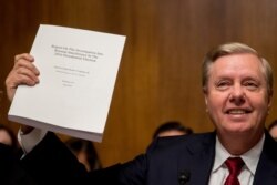Chairman Sen. Lindsey Graham, R-S.C., holds up a copy of the Mueller Report during a Senate Judiciary Committee hearing on Capitol Hill in Washington, May 1, 2019.