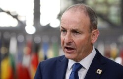 Ireland's Prime Minister Micheal Martin speaks with the media as he arrives for an EU summit in Brussels, Oct. 16, 2020.