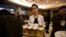 FILE - A North Korean waitress prepares to serve beer at the Mansugyo Soft Drink restaurant in Pyongyang.