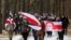 Opposition supporters carry historical white-red-white flags of Belarus as they attend a rally to reject the presidential election results in Minsk, Belarus, Dec. 13, 2020. 